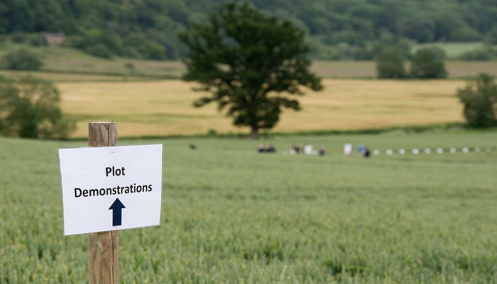 A plot demonstrations sign in a field